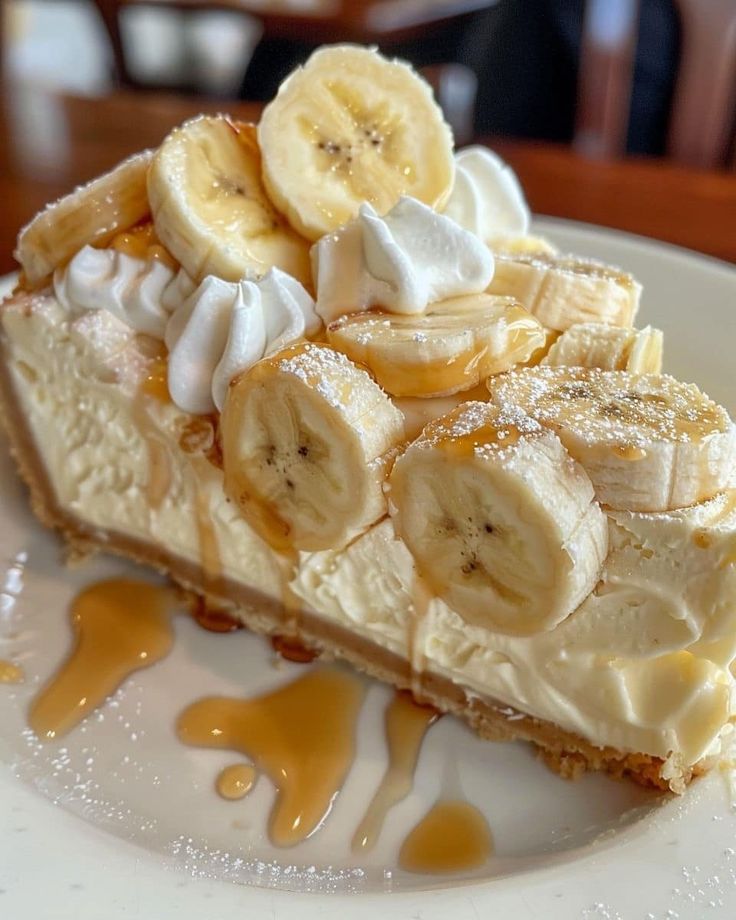 # Common Mistakes to Avoid Even experienced bakers can run into problems when making Banana Pudding Cheesecake. Fortunately, most issues are easy to avoid with the right techniques. ## 1. Using Cold Ingredients One of the biggest mistakes is using cream cheese, eggs, or sour cream straight from the refrigerator. Cold ingredients don't blend smoothly, often leaving lumps in the batter. For the creamiest texture, let all refrigerated ingredients sit at room temperature for 30 to 60 minutes before mixing. ## 2. Overmixing the Batter It's tempting to keep mixing until the batter looks perfectly fluffy, but overmixing incorporates too much air. During baking, those air bubbles expand and collapse, which can cause the cheesecake to crack. Mix only until each ingredient is fully incorporated. ## 3. Skipping the Water Bath Although a water bath isn't absolutely required, it greatly improves the final texture. The gentle, moist heat helps the cheesecake bake evenly and reduces the chances of cracks. Wrap the outside of your springform pan in aluminium foil before placing it in the hot water to prevent leaks. ## 4. Overbaking A cheesecake continues cooking as it cools. If you bake until the centre is completely firm, it will likely become dry and dense. The cheesecake is ready when the edges are set but the centre still jiggles slightly when gently shaken. ## 5. Cutting Before Chilling Patience is essential. Cutting into a warm cheesecake results in messy slices and a softer texture. For the best consistency, refrigerate the cheesecake for at least six hours, though overnight chilling is highly recommended. ## 6. Adding Bananas Too Early Fresh banana slices brown quickly when exposed to air. For the freshest appearance, decorate the cheesecake with banana slices just before serving. --- # Expert Tips for the Best Banana Pudding Cheesecake Small details can make a big difference in both flavour and presentation. * Use fully ripe bananas with yellow skins and brown speckles for the sweetest, richest banana flavour. * Choose full-fat cream cheese instead of reduced-fat varieties for a smoother, creamier texture. * Bake the cheesecake on the middle oven rack for even heat distribution. * Chill the cheesecake overnight to allow the flavours to fully develop. * Run a thin knife around the edge of the pan before removing the springform ring to prevent sticking. * Warm your knife under hot water and wipe it clean between slices for perfectly neat servings. * Garnish immediately before serving to keep bananas looking fresh. * Store leftovers in an airtight container to preserve moisture and flavour. --- # Delicious Variations One of the best things about Banana Pudding Cheesecake is how easy it is to customise. ## No-Bake Banana Pudding Cheesecake Skip the baking altogether by using whipped topping and gelatin to stabilise the filling. This version is perfect for warm summer days when you don't want to turn on the oven. ## Chocolate Banana Pudding Cheesecake Add melted dark or milk chocolate to the filling or drizzle chocolate ganache over the finished cheesecake. Chocolate and banana make a classic flavour combination. ## Caramel Banana Cheesecake Layer salted caramel sauce over the crust or drizzle it generously across the top before serving for an indulgent twist. ## Peanut Butter Banana Cheesecake Mix creamy peanut butter into the filling or swirl it through the batter before baking. The nutty flavour pairs beautifully with bananas. ## Mini Banana Pudding Cheesecakes Prepare the recipe in muffin tins lined with paper cases for individual servings. These are ideal for parties, weddings, and dessert tables. ## Gluten-Free Version Replace the vanilla wafer cookies with gluten-free vanilla biscuits or gluten-free graham crackers to make the dessert suitable for those avoiding gluten. ## Extra Banana Lovers' Version Layer thin banana slices between the crust and cheesecake filling for an even more pronounced banana flavour in every bite. --- # Nutritional Information The exact nutritional values will vary depending on the brands and ingredients used. The following estimates are based on one slice from a 12-slice cheesecake. | Nutrient | Approximate Amount | | ------------- | -----------------: | | Calories | 470 kcal | | Protein | 8 g | | Carbohydrates | 37 g | | Sugars | 27 g | | Fat | 32 g | | Saturated Fat | 19 g | | Cholesterol | 125 mg | | Sodium | 310 mg | | Fibre | 1 g | | Potassium | 250 mg | Because this dessert is rich and satisfying, a moderate slice is often enough to satisfy your sweet cravings. --- # Frequently Asked Questions (FAQ) ## Can I make Banana Pudding Cheesecake ahead of time? Yes. In fact, it tastes even better after chilling overnight. Preparing it one day in advance allows the flavours to blend beautifully. ## Can I freeze Banana Pudding Cheesecake? Absolutely. Wrap the cheesecake tightly in plastic wrap followed by aluminium foil. Freeze for up to two months. Thaw overnight in the refrigerator before serving. ## Why did my cheesecake crack? Cracks usually result from overmixing, overbaking, sudden temperature changes, or skipping the water bath. Fortunately, whipped cream topping easily covers minor cracks. ## Can I use frozen bananas? Fresh ripe bananas provide the best texture and flavour. Frozen bananas may release extra moisture and make the filling softer. ## Which cookies work best for the crust? Vanilla wafer cookies are the traditional choice because they recreate the classic banana pudding flavour. Graham crackers or digestive biscuits also work well. ## How should I store leftovers? Keep the cheesecake covered in the refrigerator for up to five days. Avoid leaving it at room temperature for extended periods. ## Can I make this recipe without sour cream? Yes. Plain Greek yoghurt is an excellent substitute and still produces a creamy filling. ## Can I use homemade whipped cream? Definitely. Fresh homemade whipped cream offers a lighter texture and fresher flavour than many store-bought alternatives. ## How do I know when the cheesecake is finished baking? The edges should appear firm while the centre still has a slight wobble. It will continue setting as it cools. ## Can children help make this recipe? Yes. Children can crush the cookies, mash the bananas, stir ingredients, and decorate the finished cheesecake with whipped cream and cookie crumbs under adult supervision. --- # Conclusion Banana Pudding Cheesecake is the ultimate dessert for anyone who loves creamy, comforting flavours. By combining the rich texture of classic cheesecake with the nostalgic taste of Southern banana pudding, this recipe creates a show-stopping treat that's perfect for holidays, birthdays, potlucks, or simply enjoying at home. Success comes down to a few simple principles: use high-quality ingredients, allow refrigerated ingredients to reach room temperature, avoid overmixing, bake gently, and give the cheesecake plenty of time to chill before serving. These small steps make a noticeable difference in both texture and flavour. Another reason this dessert has become so popular is its versatility. Whether you prefer chocolate, caramel, peanut butter, or a refreshing no-bake version, Banana Pudding Cheesecake can easily be adapted to suit different tastes and occasions. With its buttery vanilla wafer crust, silky cheesecake filling, sweet banana flavour, and irresistible toppings, every slice delivers a perfect balance of crunch, creaminess, and sweetness. It's a dessert that looks impressive, tastes even better, and is sure to become a favourite recipe you'll return to again and again. Whether you're baking for family, friends, or a special celebration, this Banana Pudding Cheesecake is guaranteed to leave everyone asking for another slice—and the recipe.